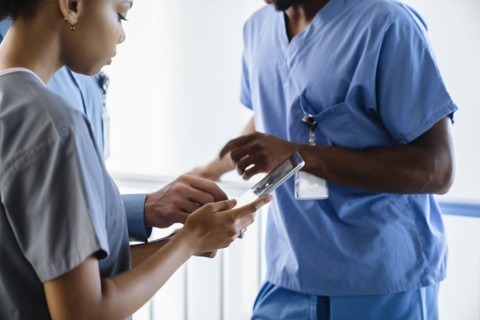 Doctor and nurses discussing digital tablet
