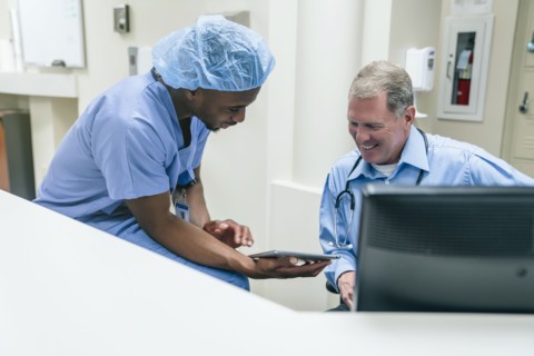 Doctor and nurse discussing digital tablet