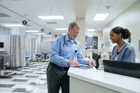 Doctor and nurse using digital tablet