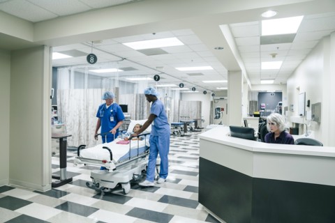 Nurses pushing gurney in hospital