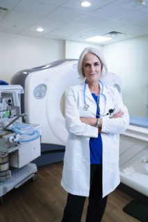Portrait of confident Caucasian doctor near scanner
