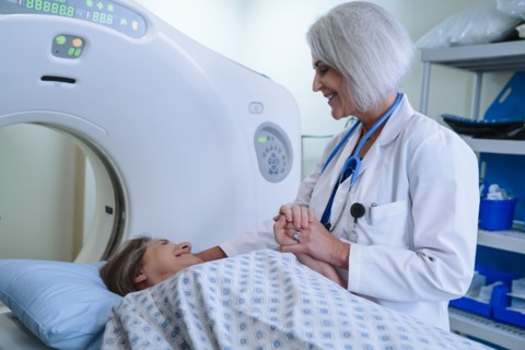 Caucasian doctor comforting patient near scanner