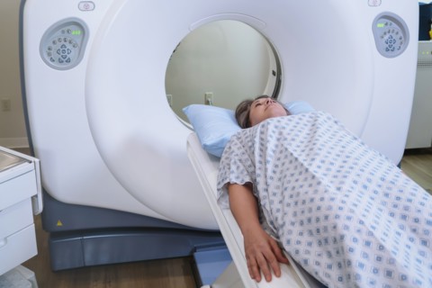Caucasian patient laying on scanner table
