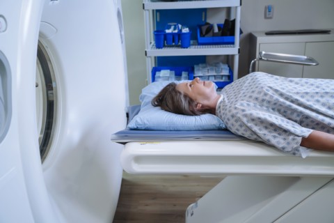 Caucasian patient laying on scanner table