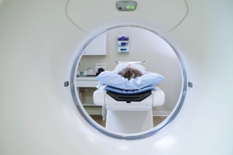 Caucasian patient laying on scanner table