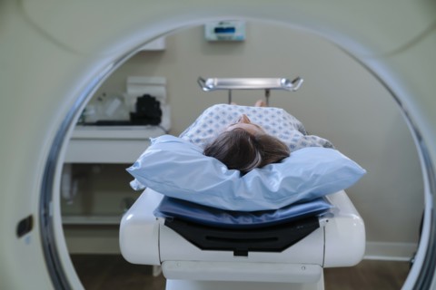 Caucasian patient laying on scanner table