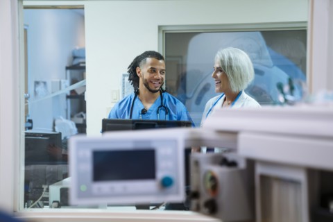 Smiling doctor and nurse talking