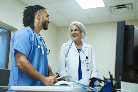 Smiling doctor and nurse talking