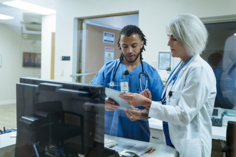Doctor and nurse discussing digital tablet