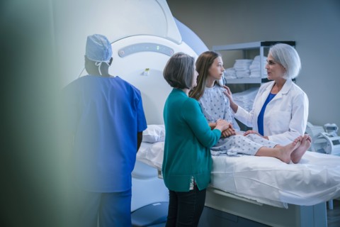 Doctor comforting patient at scanner