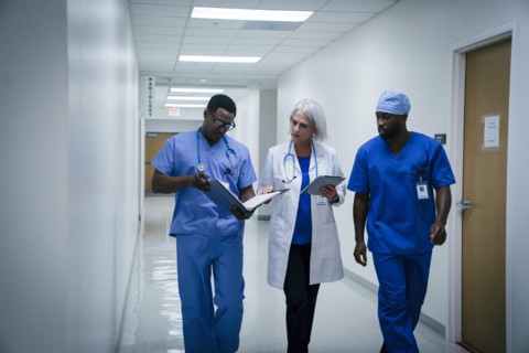 Doctor and nurses discussing paperwork in hospital