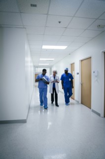 Doctor and nurses discussing paperwork in hospital