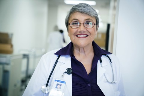 Portrait of smiling mixed race doctor