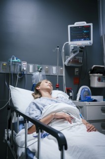 Caucasian girl sleeping in hospital bed
