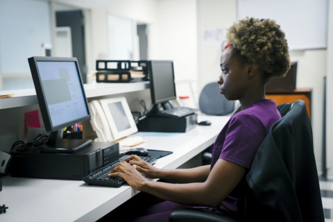 Black nurse using computer