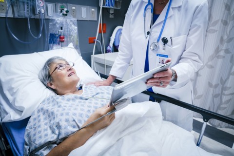 Doctor showing digital tablet to patient