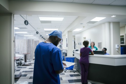 Nurse reading paperwork in hospital