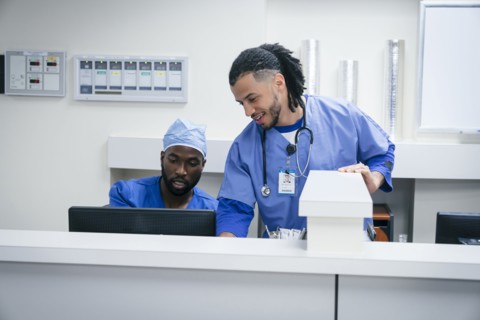 Nurses using computer in hospital