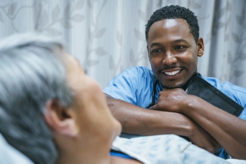 Nurse talking to patient in hospital bed