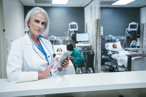 Doctor using digital tablet in hospital