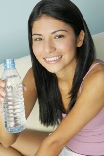 Hispanic woman holding water bottle