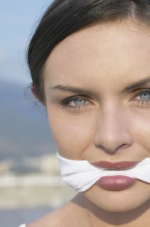 Young woman wearing gag