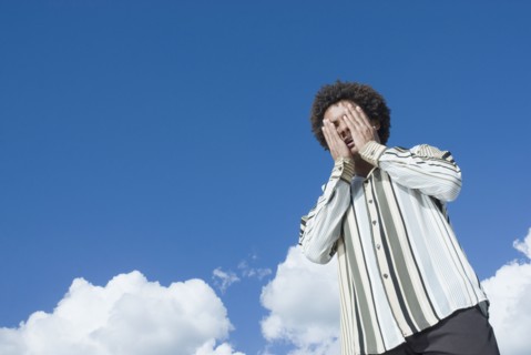 Mixed Race man with hands on face