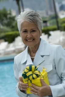 Senior Hispanic woman holding gift