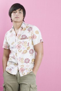 Young Hispanic man with hands in pockets