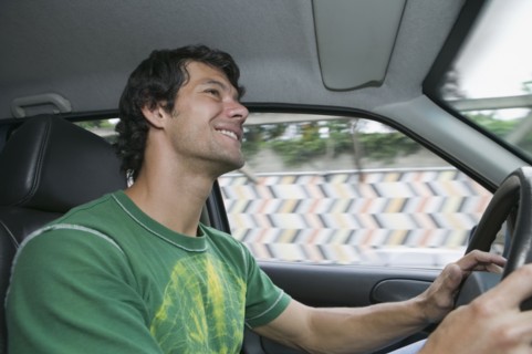 Hispanic man driving car