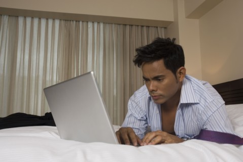 Hispanic businessman typing on laptop