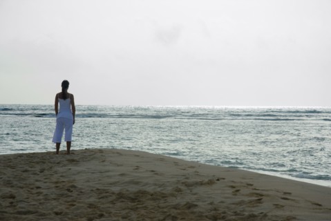 Woman looking out over ocean