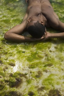 Hispanic man laying in water