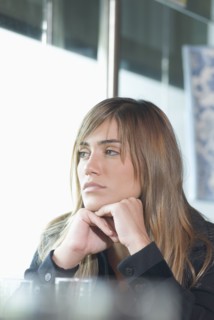 Hispanic woman looking out window