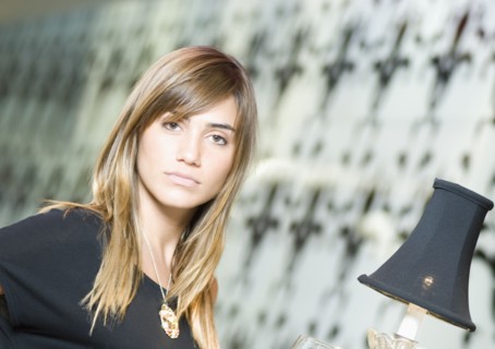 Portrait of Hispanic woman next to lamp