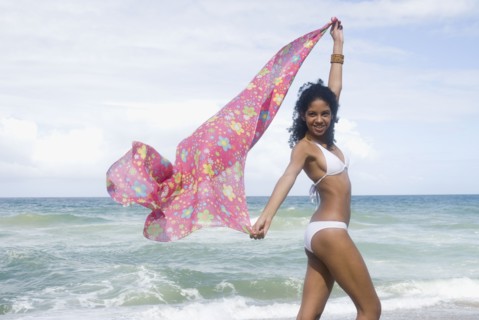 African woman in bikini at beach