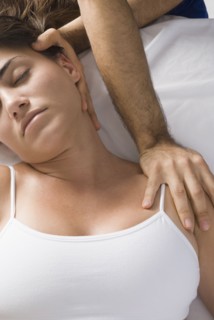 Chiropractor adjusting woman's neck