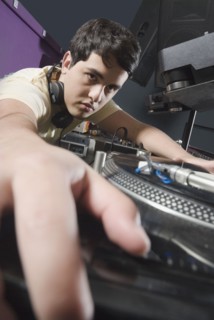 Hispanic DJ performing in nightclub