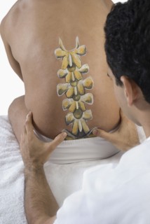 Chiropractor adjusting man's back