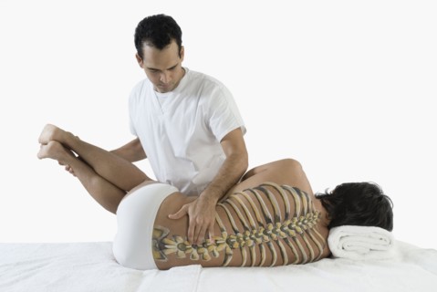 Chiropractor adjusting man's back