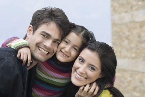 Happy Hispanic family hugging