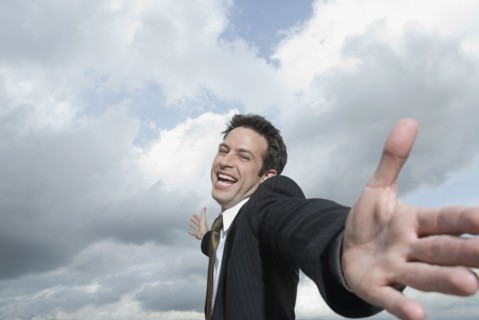 Hispanic businessman with arms outstretched