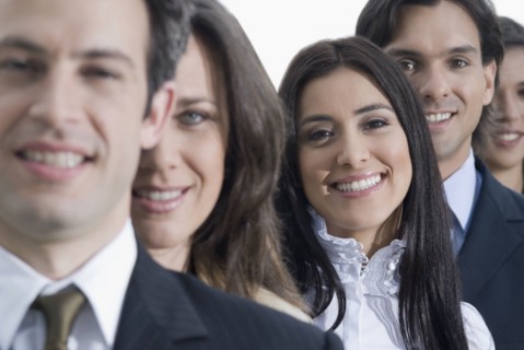 Hispanic co-workers standing in row