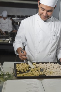 Baker working in bakery kitchen