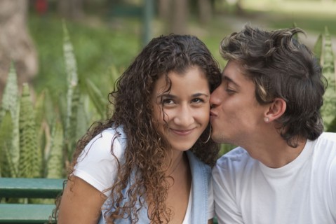 Hispanic man kissing girlfriend
