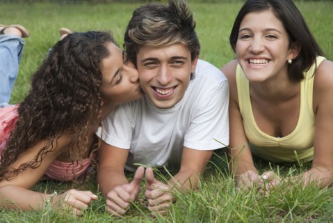 Hispanic girl kissing man on cheek