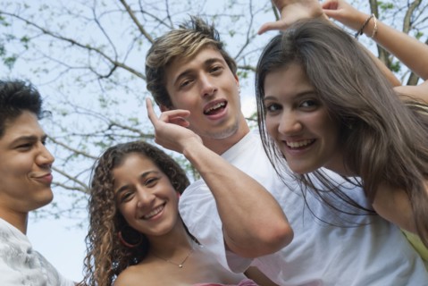 Playful Hispanic friends smiling