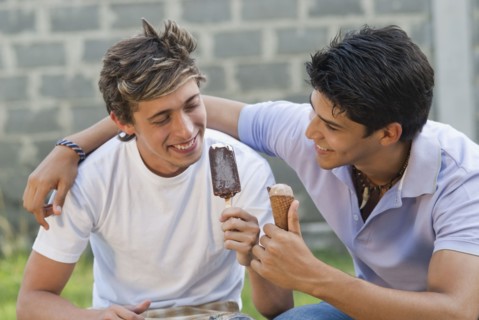 Hispanic men eating ice cream together
