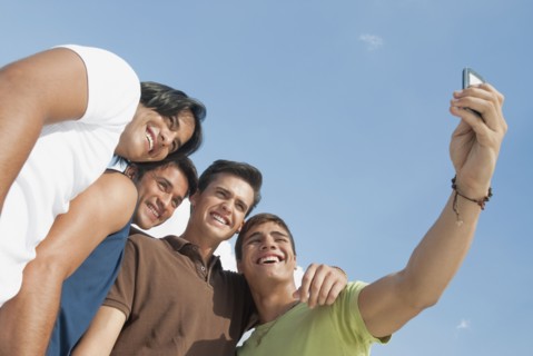 Friends taking self-portrait with cell phone
