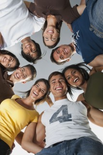 Smiling friends in huddle together